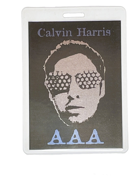 Laminated card with a portrait of Calvin Harris and 'AAA' text on a dark background