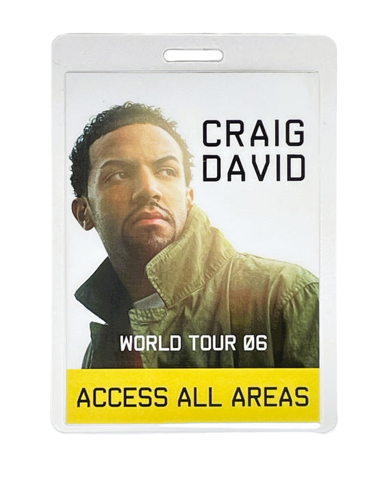 Laminated concert pass with Craig David's face and 'World Tour 06' text on a white background
