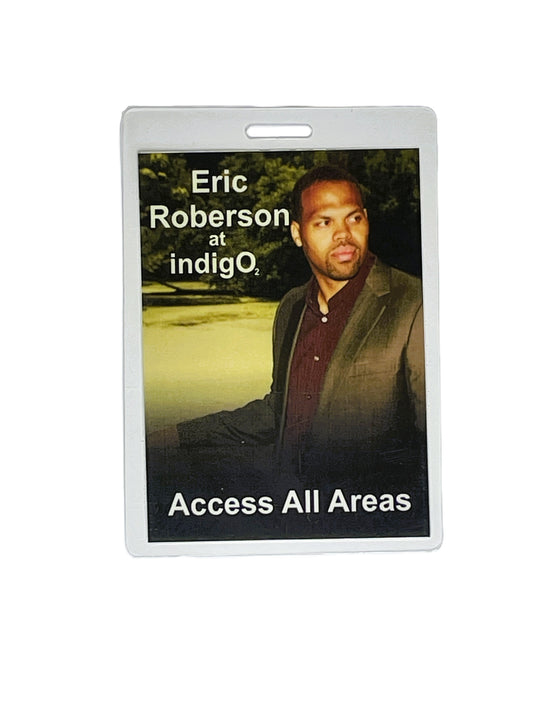 Laminated event badge with a photo of Eric Roberson and text 'Eric Roberson at indigo2 Access All Areas' on a white background.