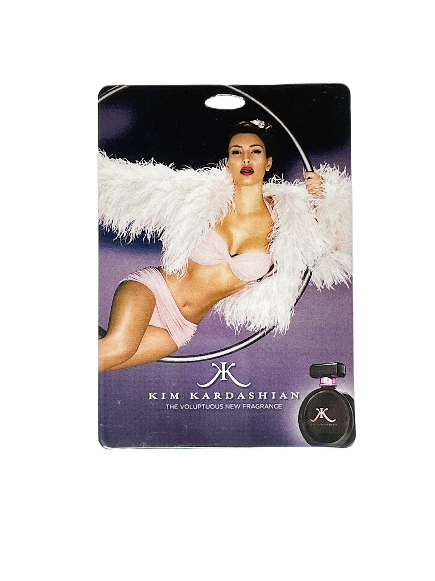 Kim Kardashian perfume pass with a model wearing lingerie and feathers.