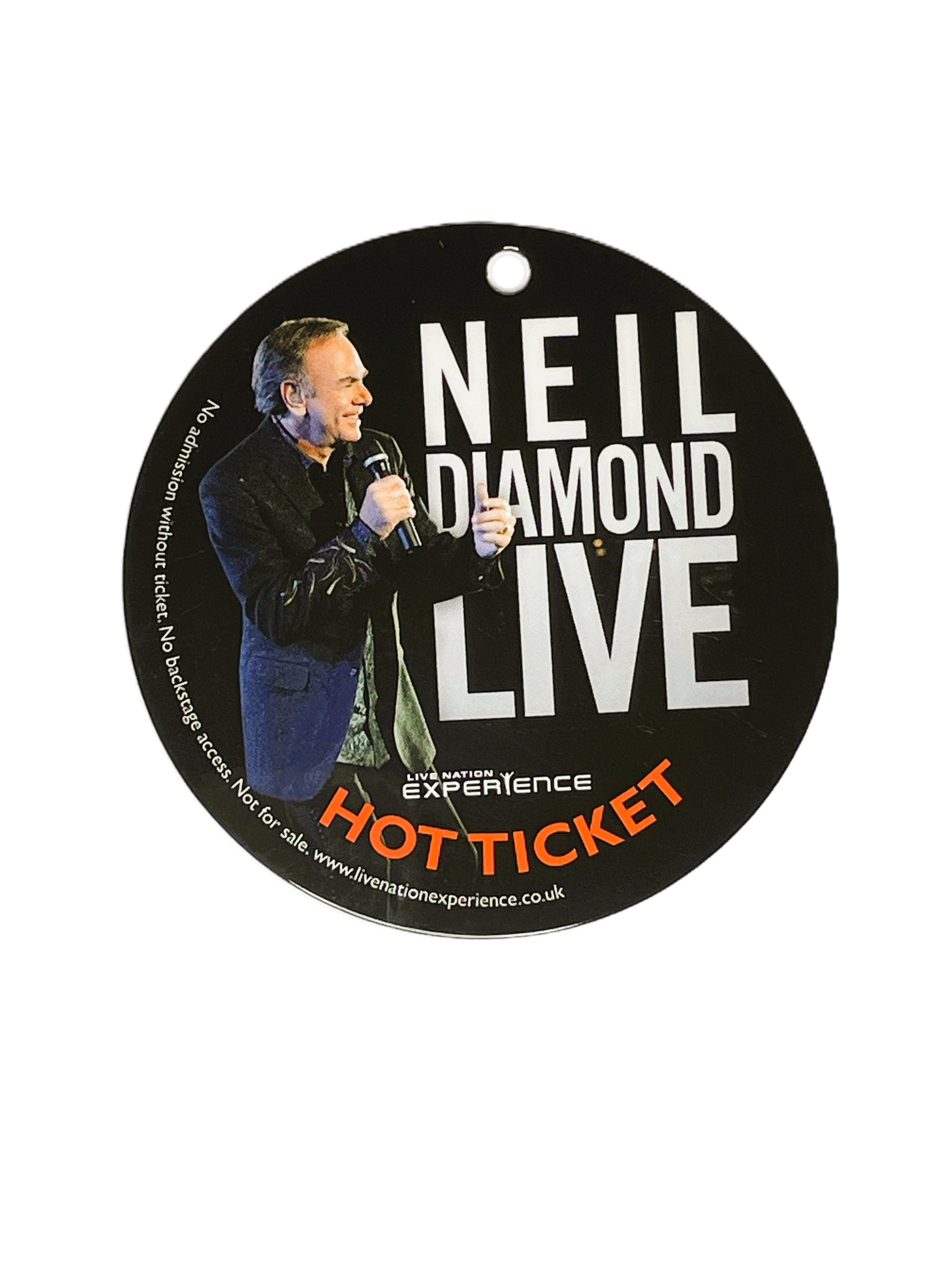 Round promotional pass for Neil Diamond Live with a photo holding a microphone.