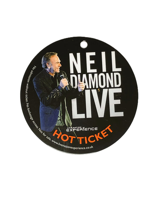 Round pass for Neil Diamond Live with a photo holding a microphone.